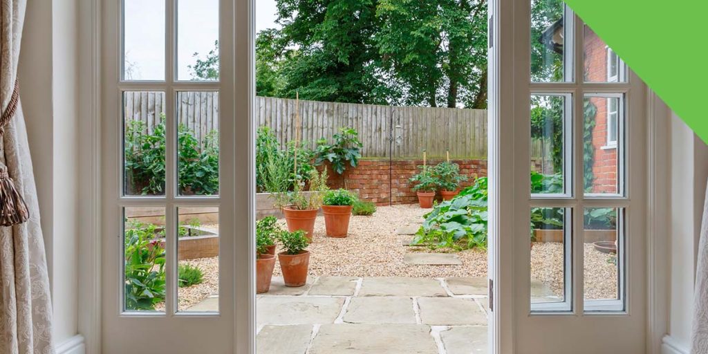 open patio door with a backyard view