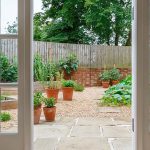 open patio door with a backyard view